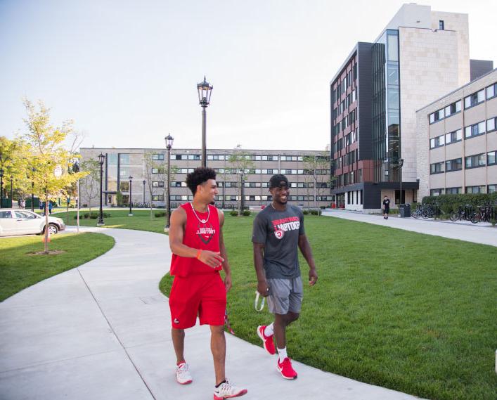 Students chat as they walk around campus.